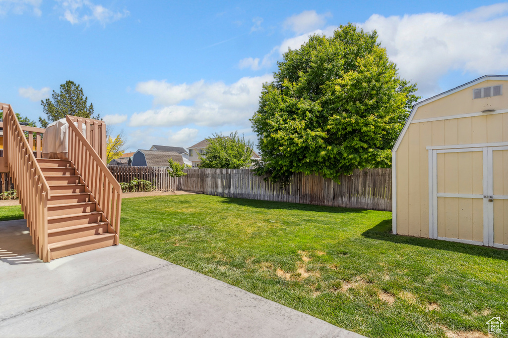 View of yard with a patio area and stairs