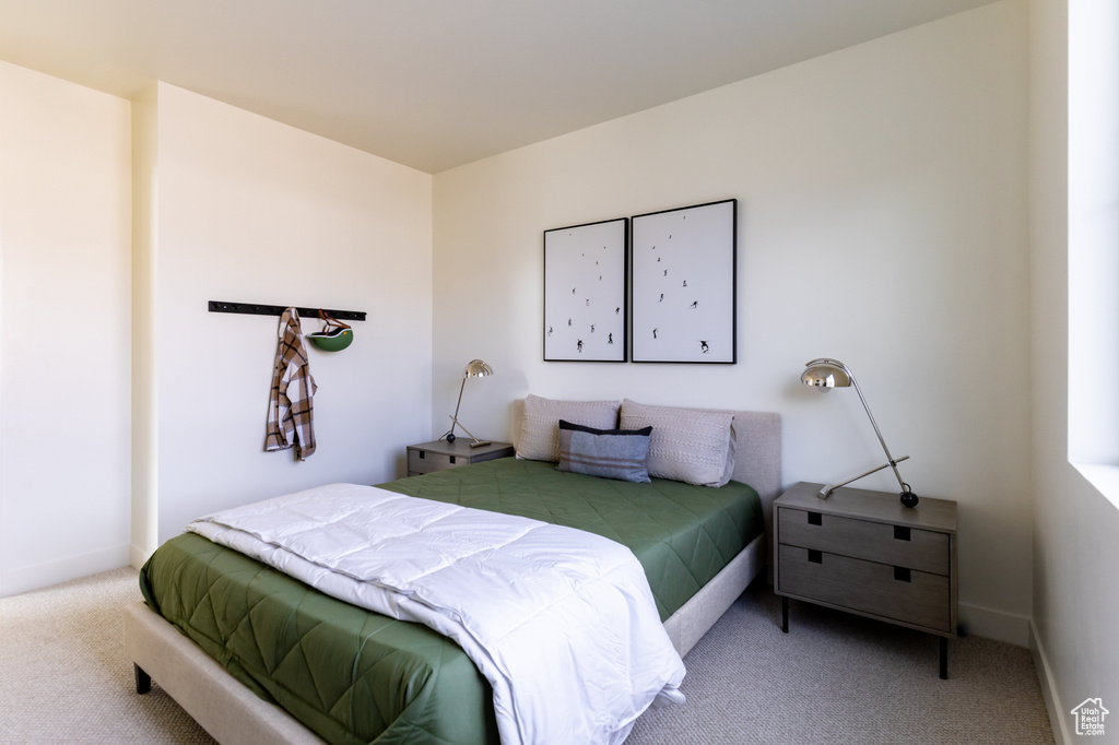 Bedroom with carpet floors and baseboards