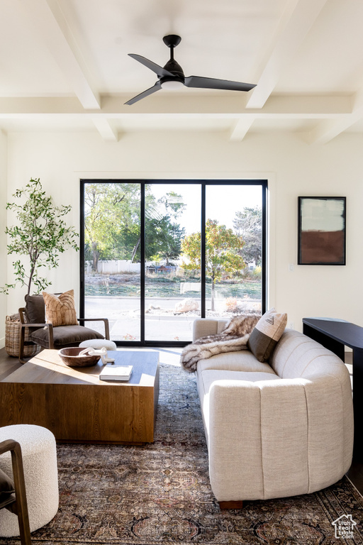 Living room featuring beam ceiling, ceiling fan, and healthy amount of natural light