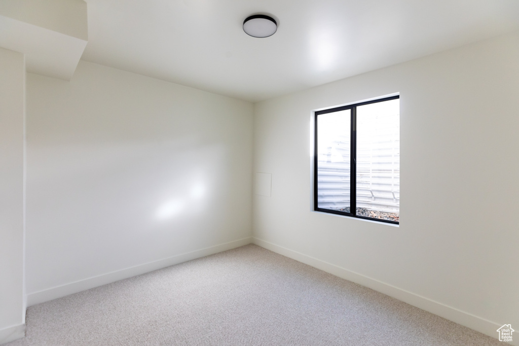 Spare room with carpet floors and baseboards