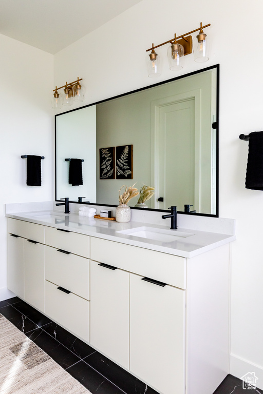 Full bath with double vanity and tile patterned flooring