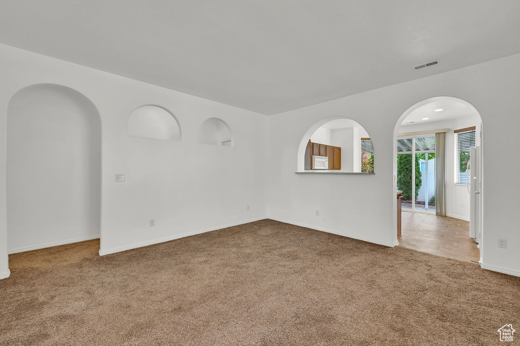 Carpeted empty room with baseboards