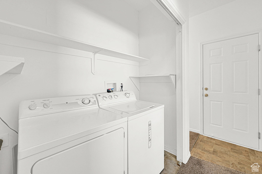 Washroom featuring washing machine and clothes dryer
