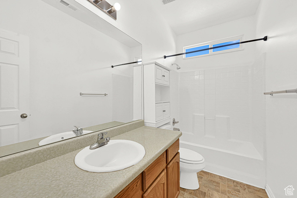 Bathroom featuring vanity, toilet, and bathing tub / shower combination