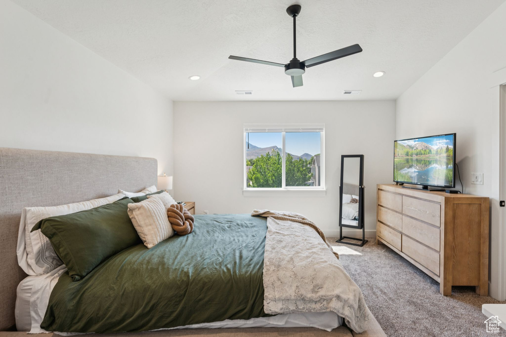 Bedroom featuring light colored carpet, ceiling fan, and recessed lighting