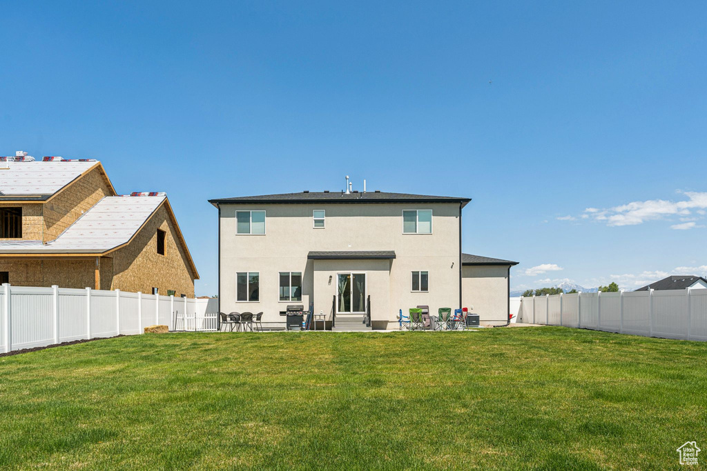 Back of property with a patio and stucco siding