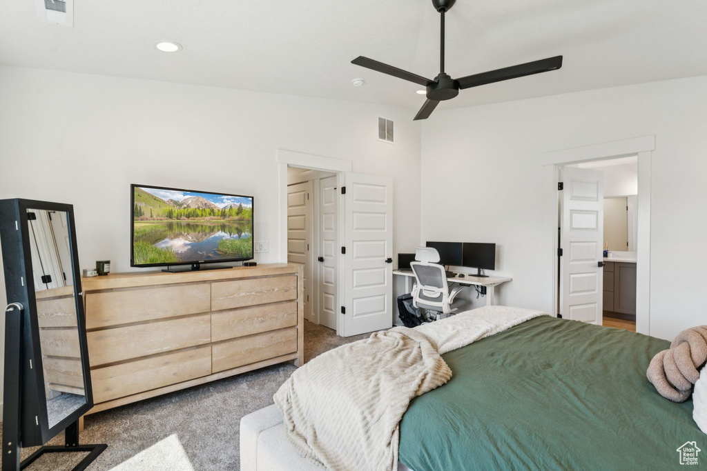 Carpeted bedroom with a desk, ceiling fan, and recessed lighting