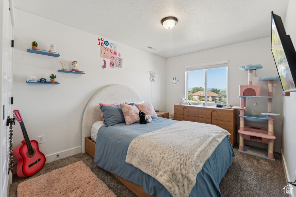 Bedroom featuring carpet floors and baseboards