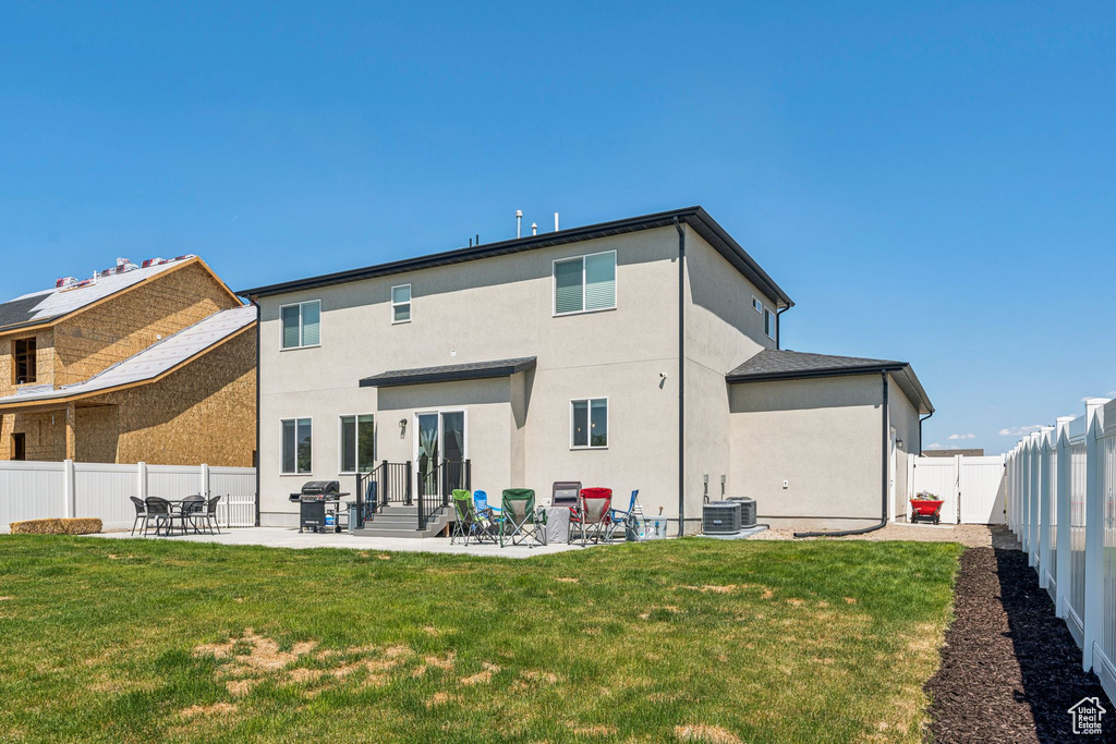 Back of house with stucco siding and a patio area