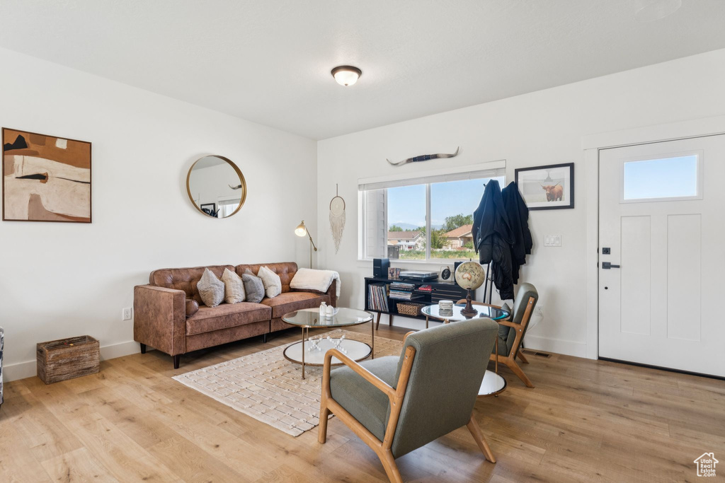 Living room featuring plenty of natural light, wood finished floors, and baseboards