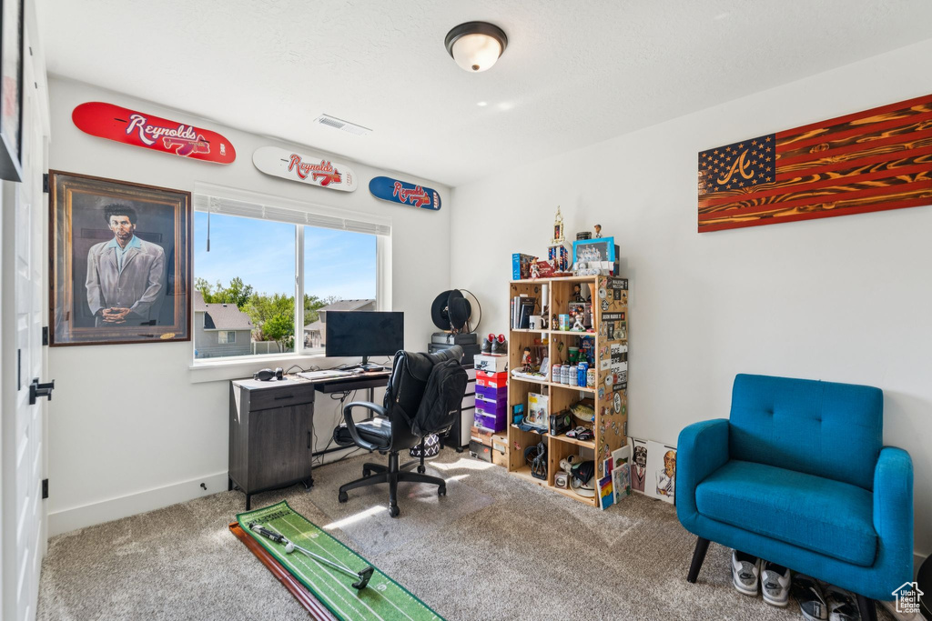 Home office featuring carpet and baseboards
