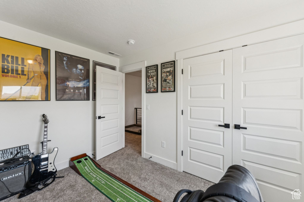 Recreation room featuring carpet floors and baseboards