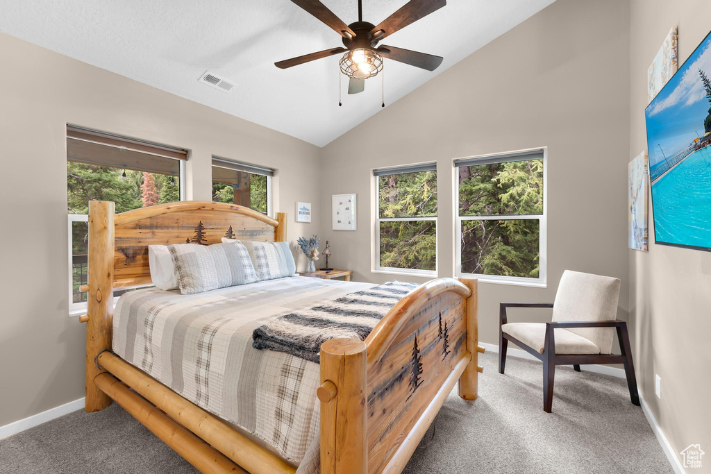 Bedroom with carpet flooring, lofted ceiling, baseboards, and ceiling fan