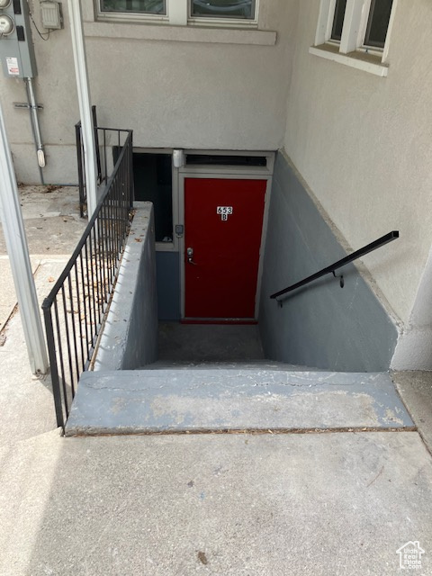 Doorway to property with stucco siding