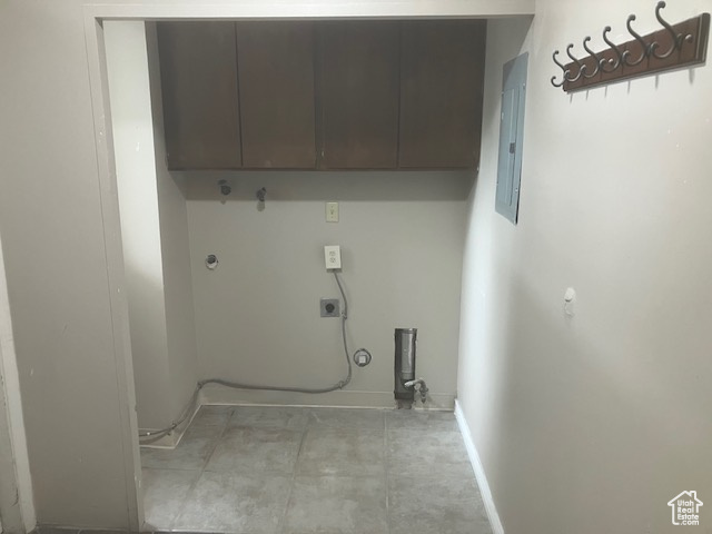 Laundry area with cabinet space, electric dryer hookup, electric panel, and baseboards