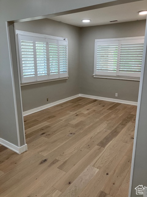 Empty room featuring wood finished floors and baseboards