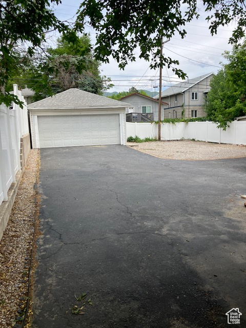 View of yard featuring a garage and an outdoor structure