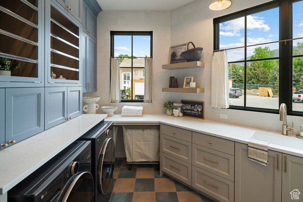Washroom featuring washer and dryer and cabinet space
