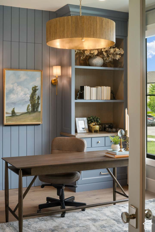Office area featuring wood finished floors and built in features