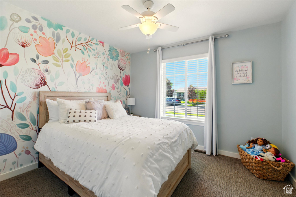 Bedroom featuring carpet flooring, baseboards, and ceiling fan