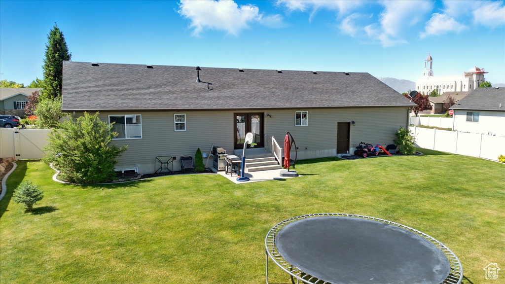 Back of property featuring roof with shingles and a gate