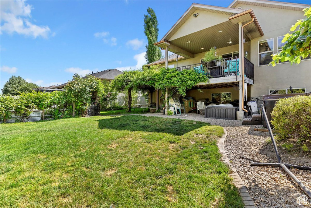 View of green lawn with a patio area