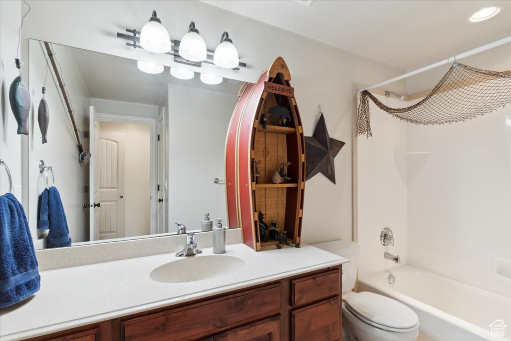 Bathroom with vanity, washtub / shower combination, and toilet