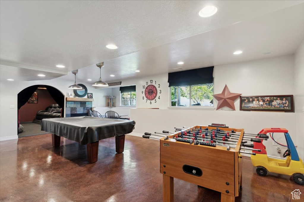 Rec room with concrete floors, recessed lighting, billiards table, baseboards, and arched walkways