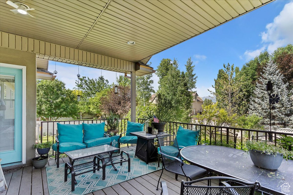 Wooden terrace featuring an outdoor living space and outdoor dining area