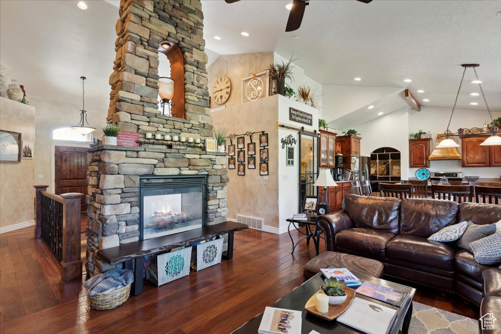 Living area featuring baseboards, ceiling fan, dark wood-style flooring, high vaulted ceiling, and recessed lighting