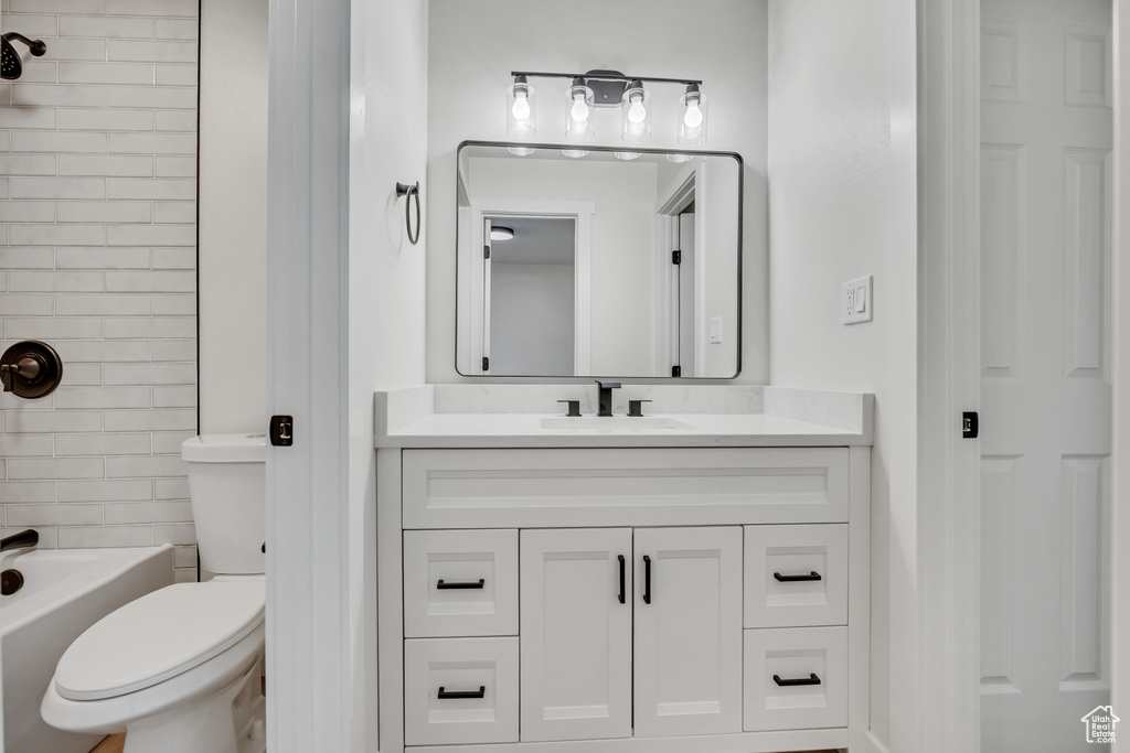 Full bath featuring vanity, toilet, and bathing tub / shower combination