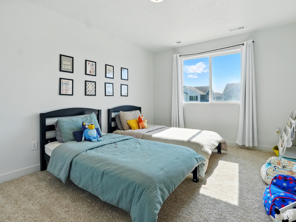 Carpeted bedroom featuring baseboards