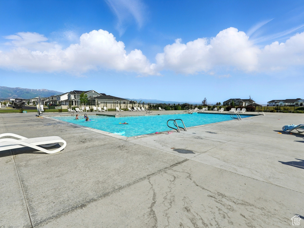 Community pool with a patio and a mountain view