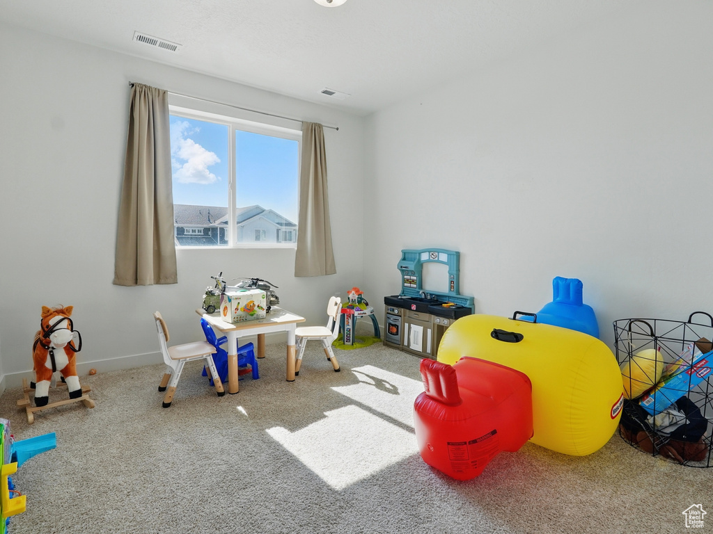 Rec room featuring carpet flooring and baseboards