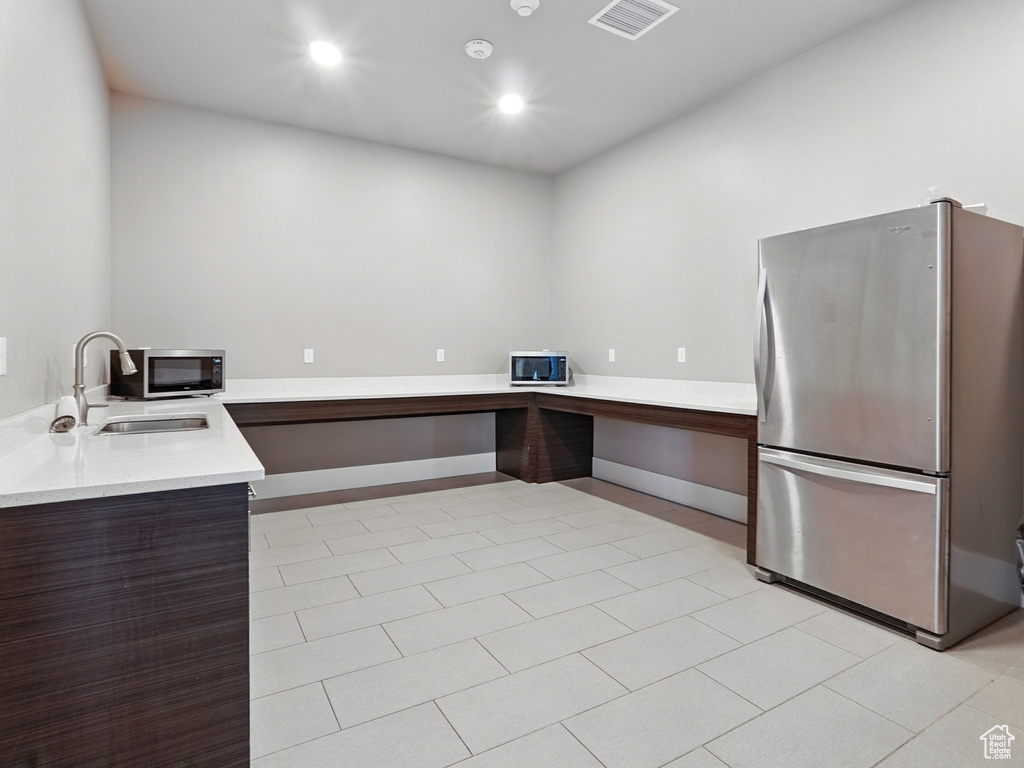 Kitchen featuring appliances with stainless steel finishes, a sink, modern cabinets, light countertops, and recessed lighting