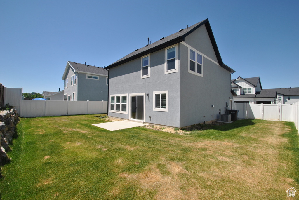 Back of property featuring a patio, stucco siding, and central air condition unit