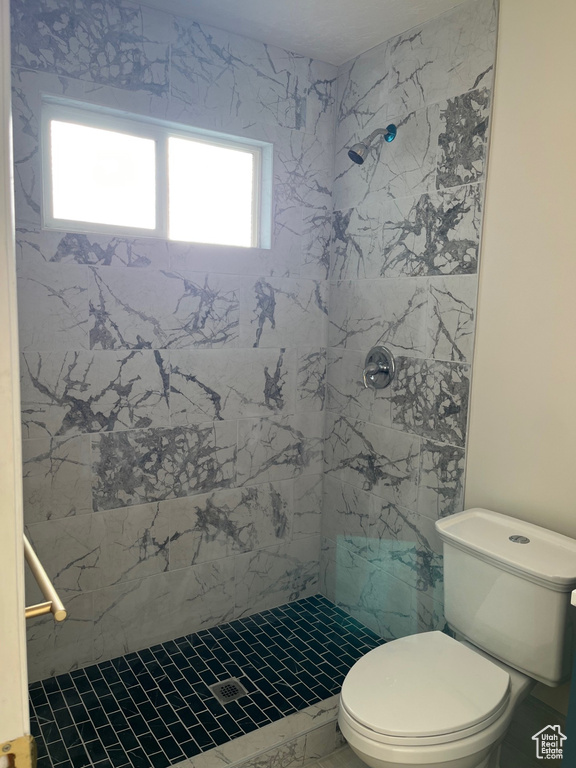 Full bathroom with a shower stall and toilet