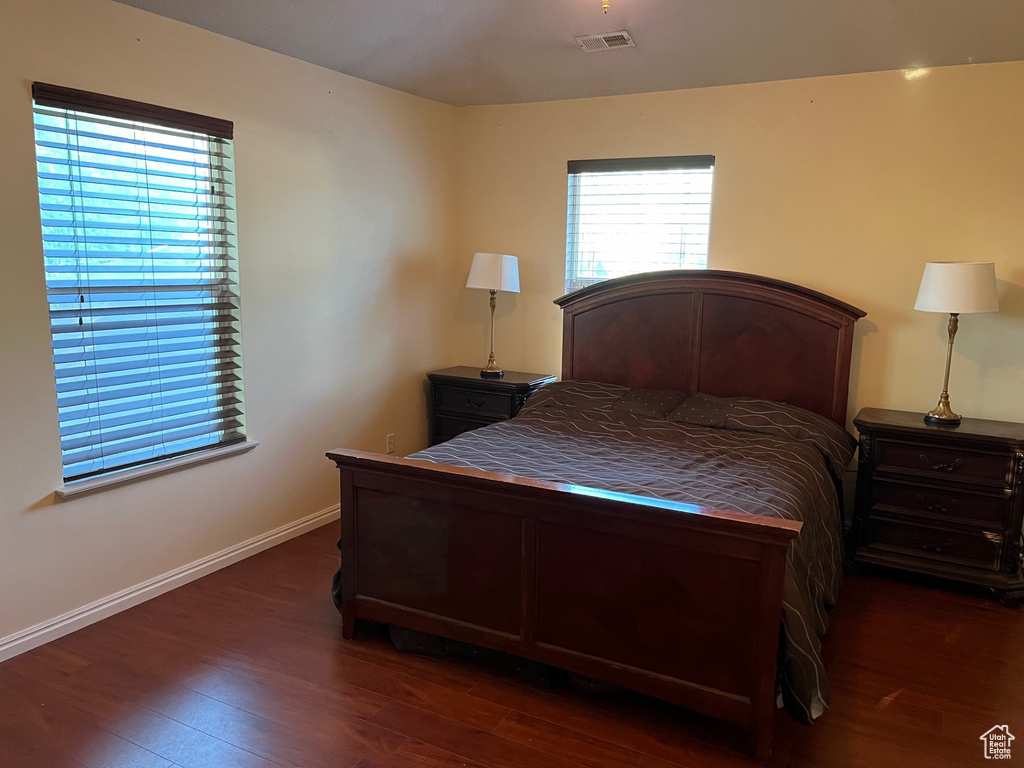 Bedroom featuring wood finished floors and baseboards