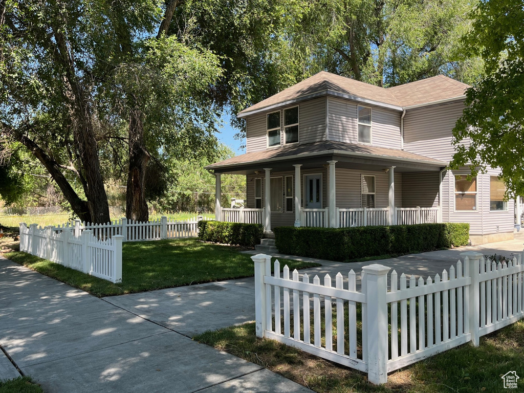 Farmhouse with a porch and roof with shingles