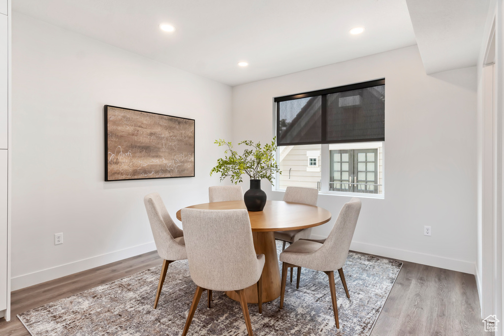 Dining room featuring wood finished floors, baseboards, and recessed lighting