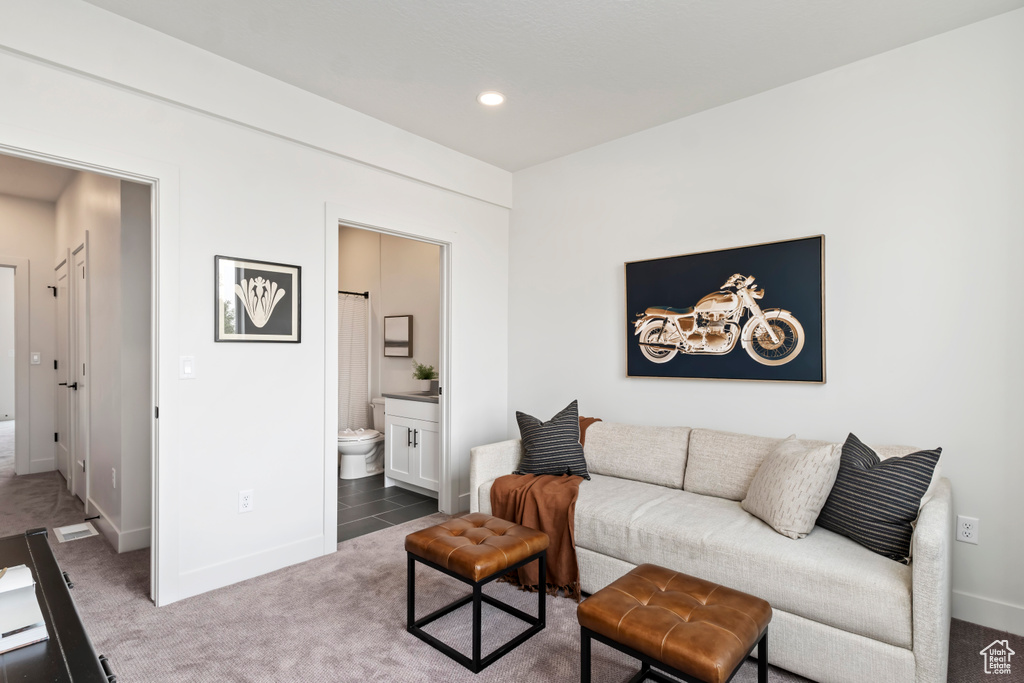 Carpeted living room with baseboards and recessed lighting