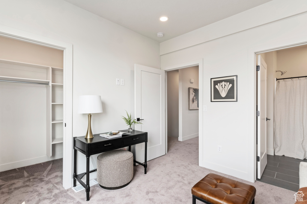 Carpeted office space with baseboards