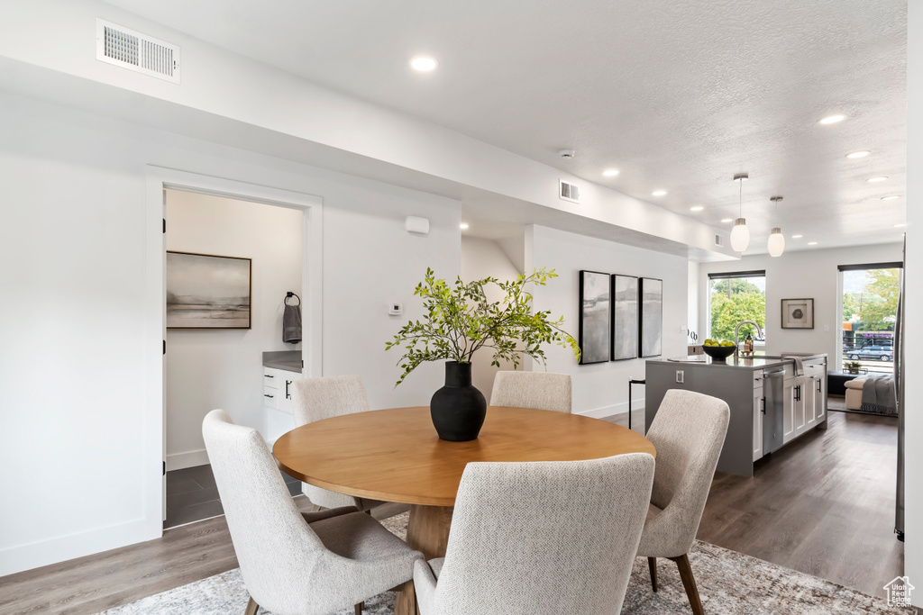 Dining space featuring recessed lighting, wood finished floors, and baseboards