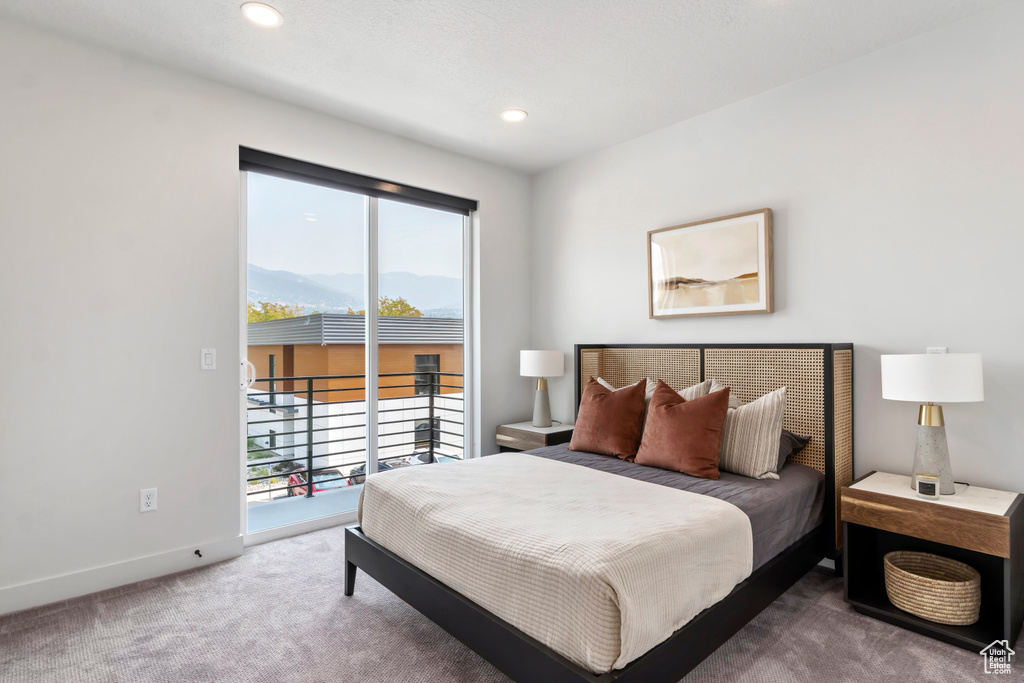 Carpeted bedroom with access to exterior, multiple windows, baseboards, a mountain view, and recessed lighting