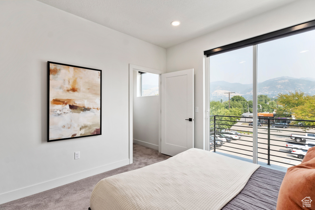 Bedroom featuring a mountain view, light colored carpet, access to outside, baseboards, and recessed lighting