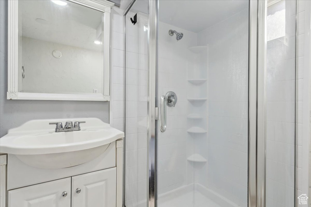 Full bathroom with a stall shower and vanity