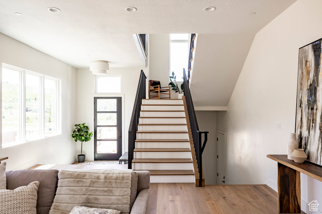 Stairs featuring wood finished floors