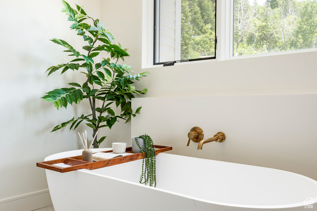 Bathroom view of a freestanding tub and baseboards