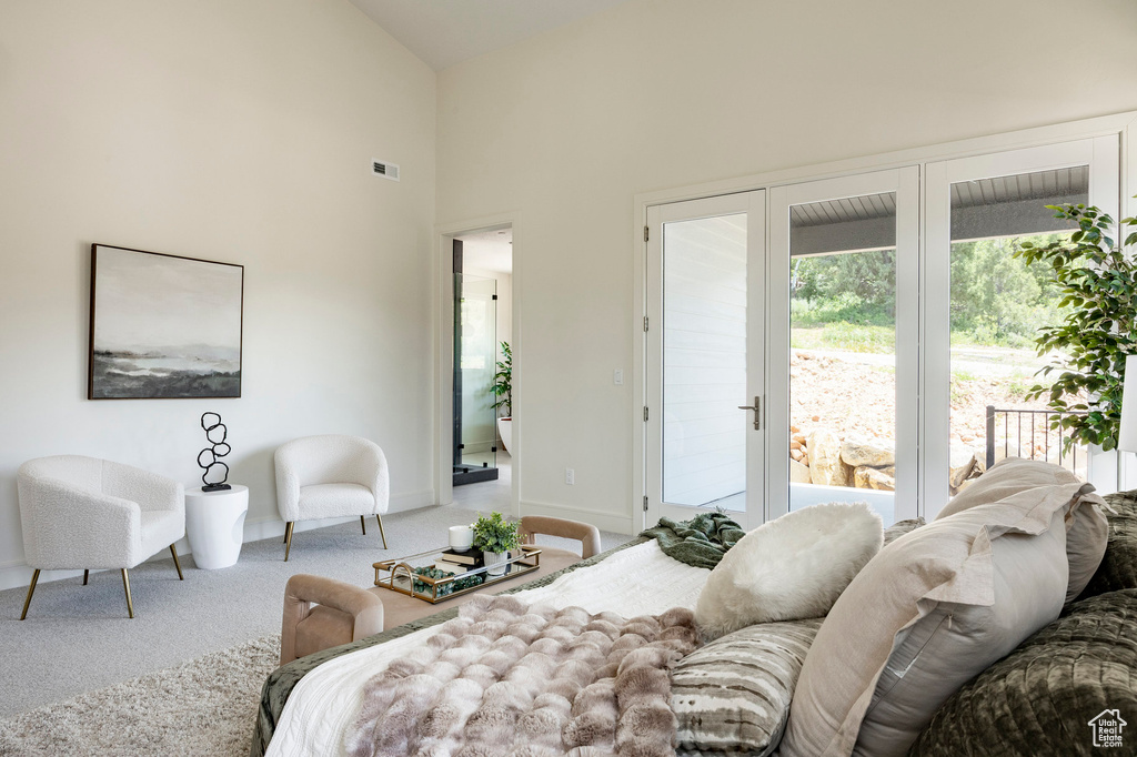 Carpeted bedroom featuring access to exterior, baseboards, and high vaulted ceiling