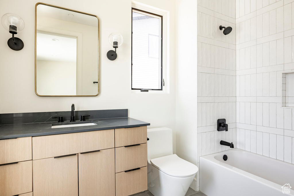 Full bath featuring vanity, toilet, and shower / bathtub combination